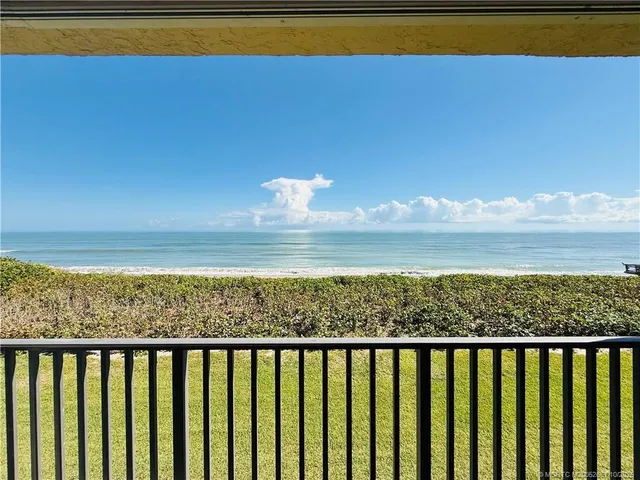a bedroom with a large bed and a flat tv screen on dresser