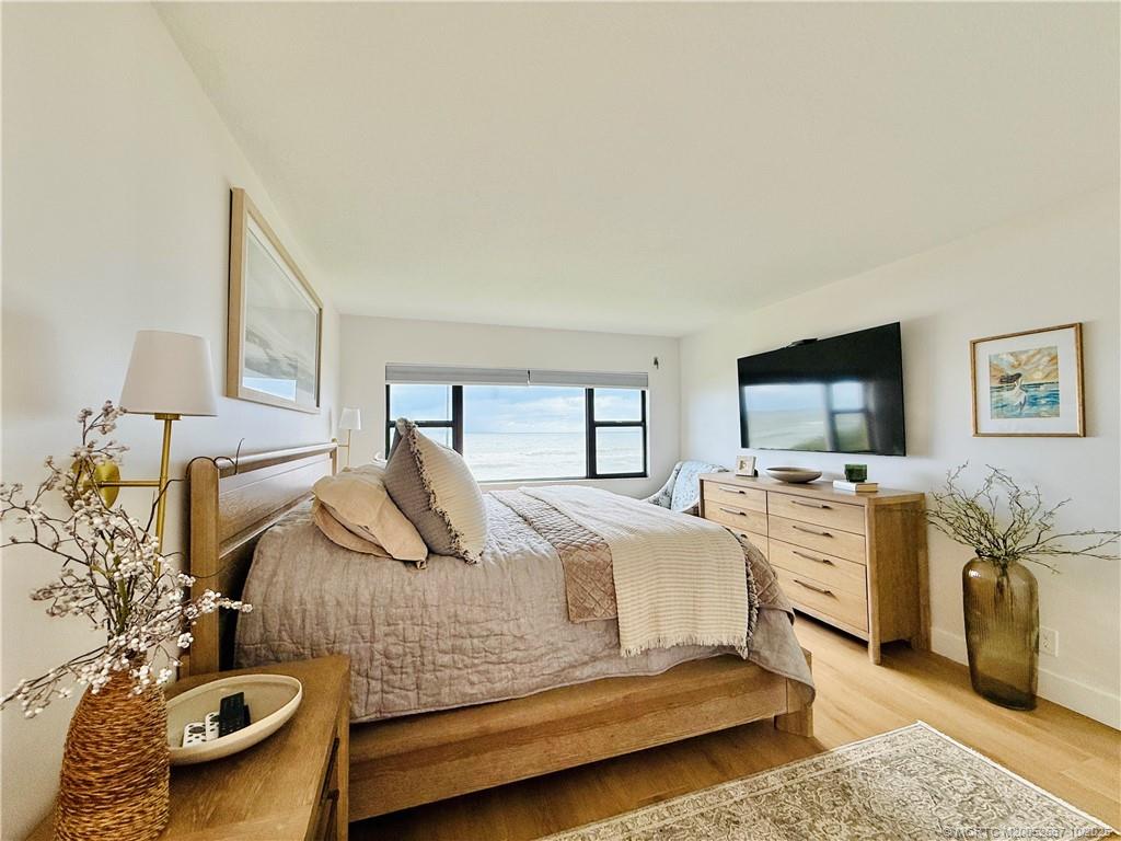 7370 South Ocean Drive, Unit 312 Jensen Beach, FL 34957 - Photo 38 of 67 a bedroom with a bed and a couch