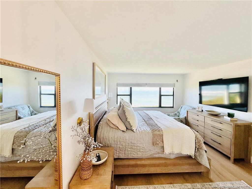 7370 South Ocean Drive, Unit 312 Jensen Beach, FL 34957 - Photo 39 of 67 a bedroom with a bed and a flat screen tv