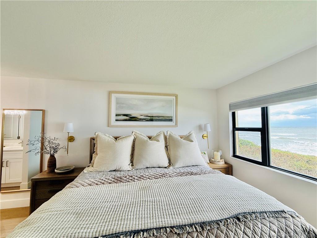 7370 South Ocean Drive, Unit 312 Jensen Beach, FL 34957 - Photo 40 of 67 a bedroom with a large bed and a large window