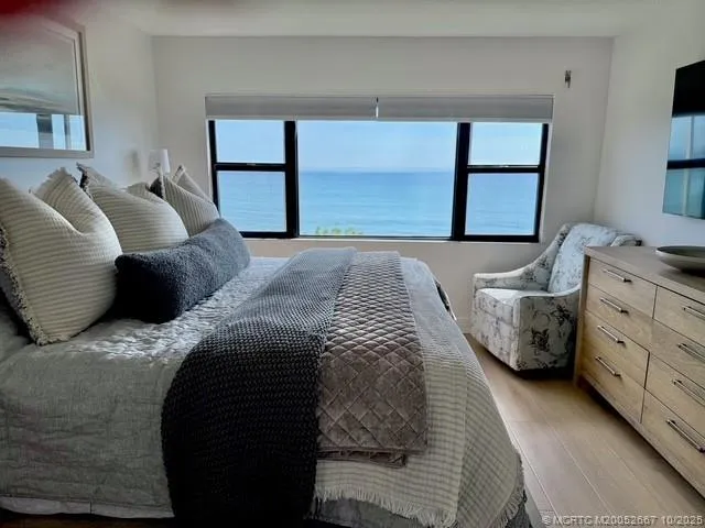a spacious bedroom with a bed and a window
