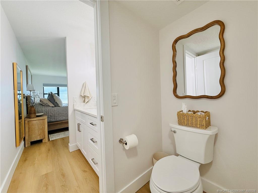 7370 South Ocean Drive, Unit 312 Jensen Beach, FL 34957 - Photo 46 of 67 a bathroom with a toilet a sink and mirror