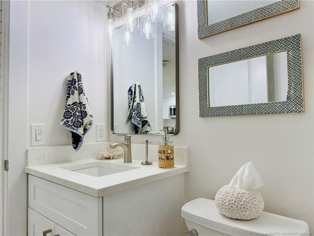7370 South Ocean Drive, Unit 312 Jensen Beach, FL 34957 - Photo 52 of 67 a bathroom with a sink and a mirror