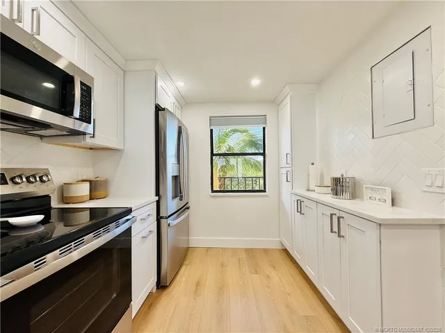 a view of kitchen with wooden floor