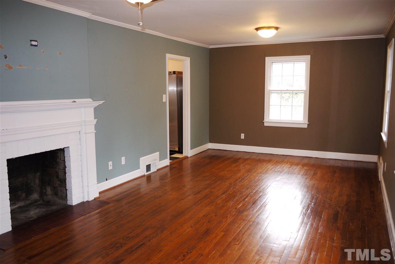 1517 Duplin Road Raleigh, NC 27607 - Photo 2 of 10 a view of an empty room with wooden floor and a window