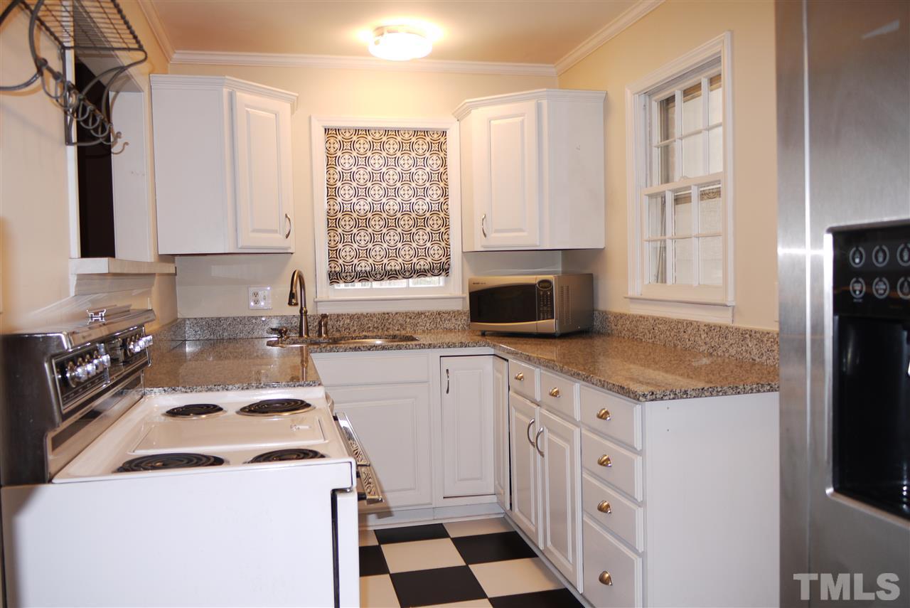 1517 Duplin Road Raleigh, NC 27607 - Photo 4 of 10 a kitchen with a stove a sink and a refrigerator