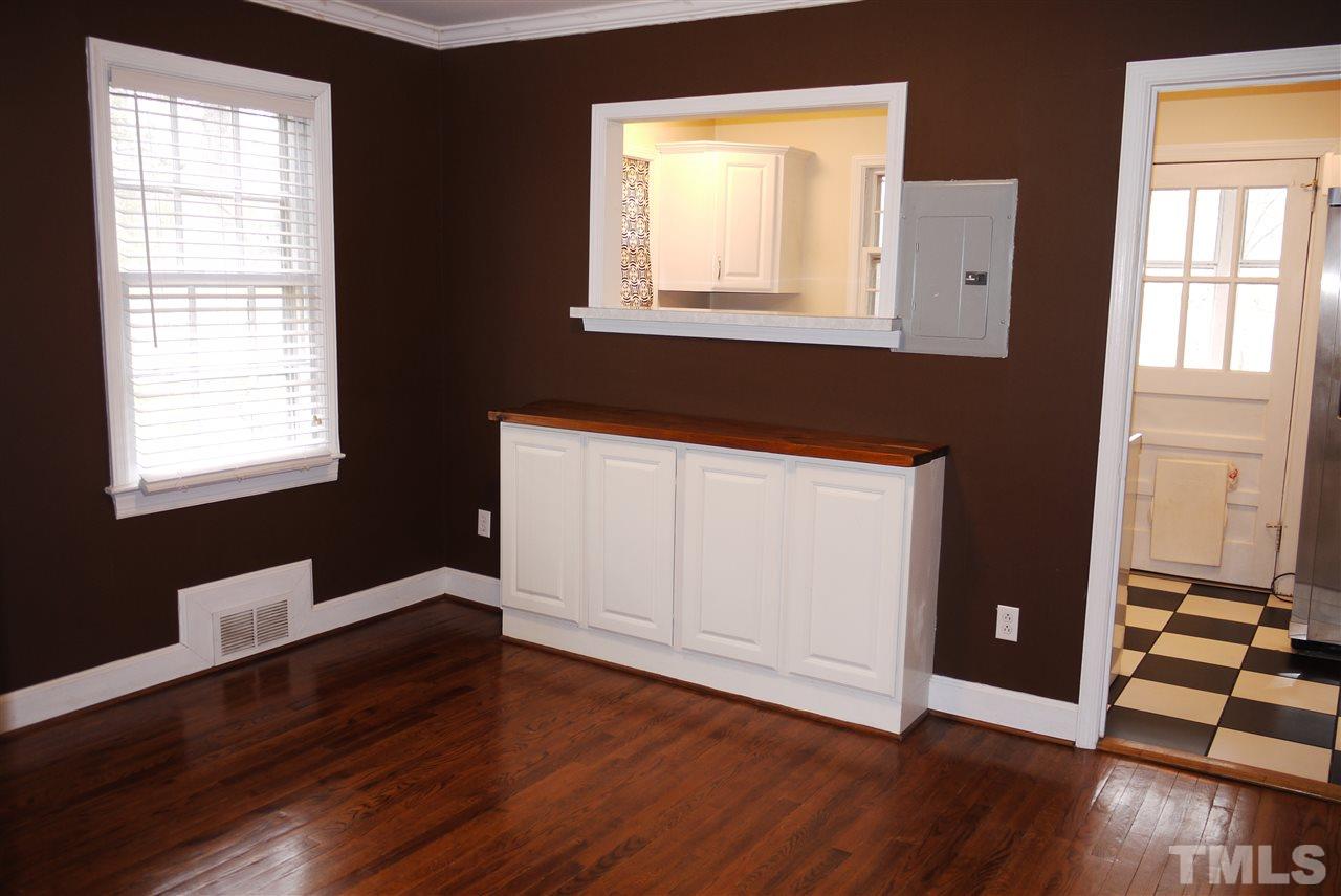 1517 Duplin Road Raleigh, NC 27607 - Photo 5 of 10 an empty room with wooden floor and windows