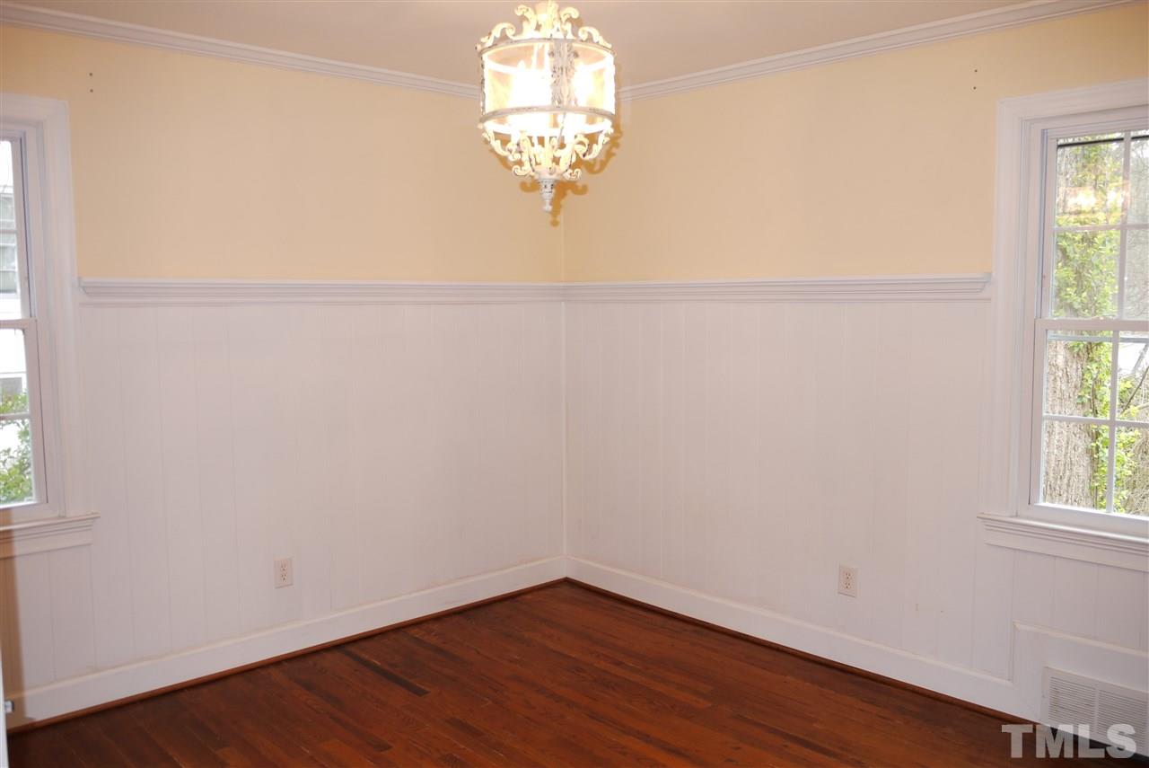 1517 Duplin Road Raleigh, NC 27607 - Photo 6 of 10 an empty room with wooden floor and windows