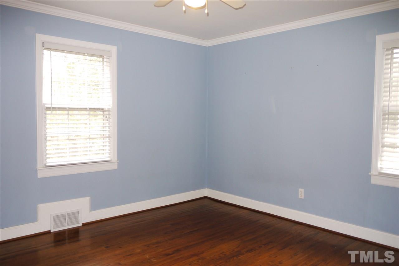 1517 Duplin Road Raleigh, NC 27607 - Photo 7 of 10 a view of an empty room with wooden floor and a window