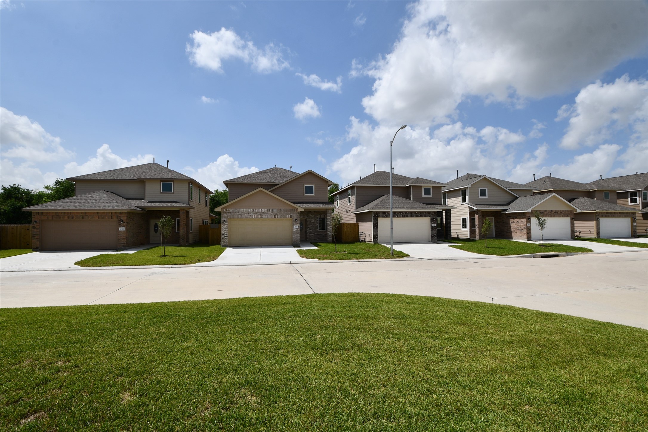 a view of multiple houses with a big yard