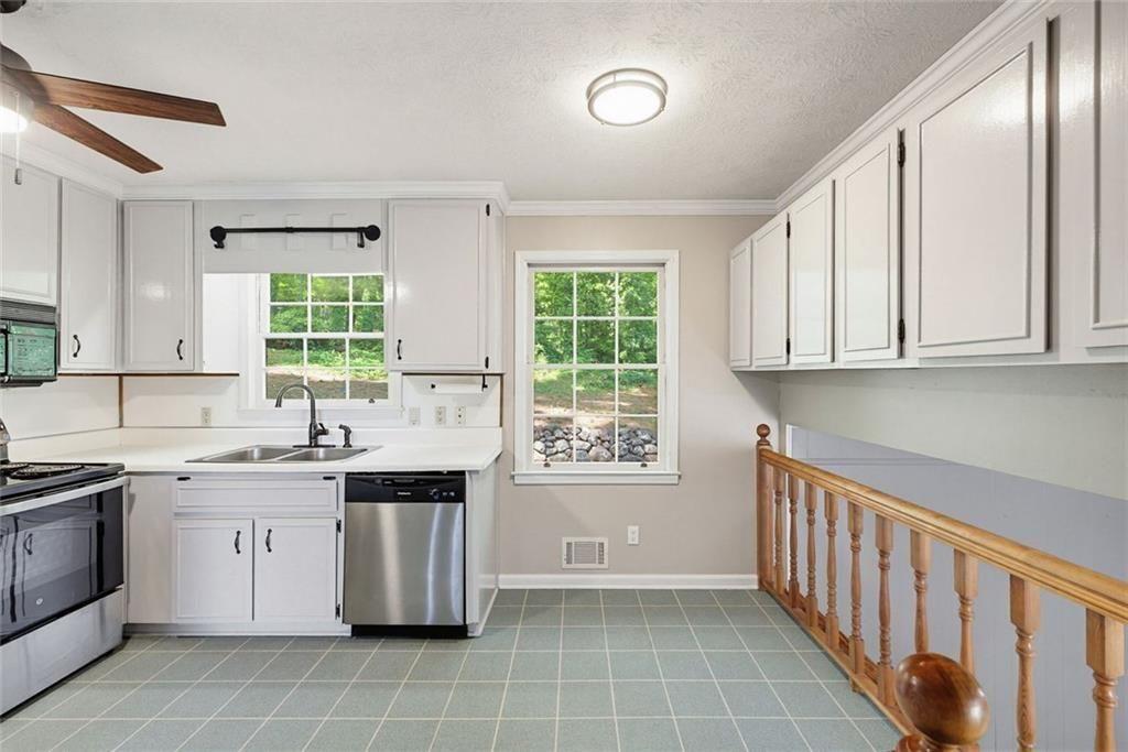 2845 Wood Forest Road Marietta, GA 30066 - Photo 11 of 26 a kitchen with a sink stove and cabinets