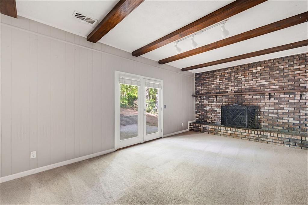 2845 Wood Forest Road Marietta, GA 30066 - Photo 12 of 26 a view of an empty room with a fireplace and a window
