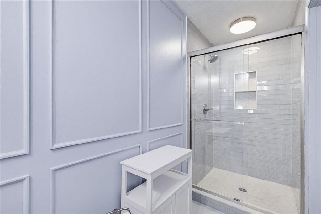 2845 Wood Forest Road Marietta, GA 30066 - Photo 15 of 26 a bathroom with a shower and a sink