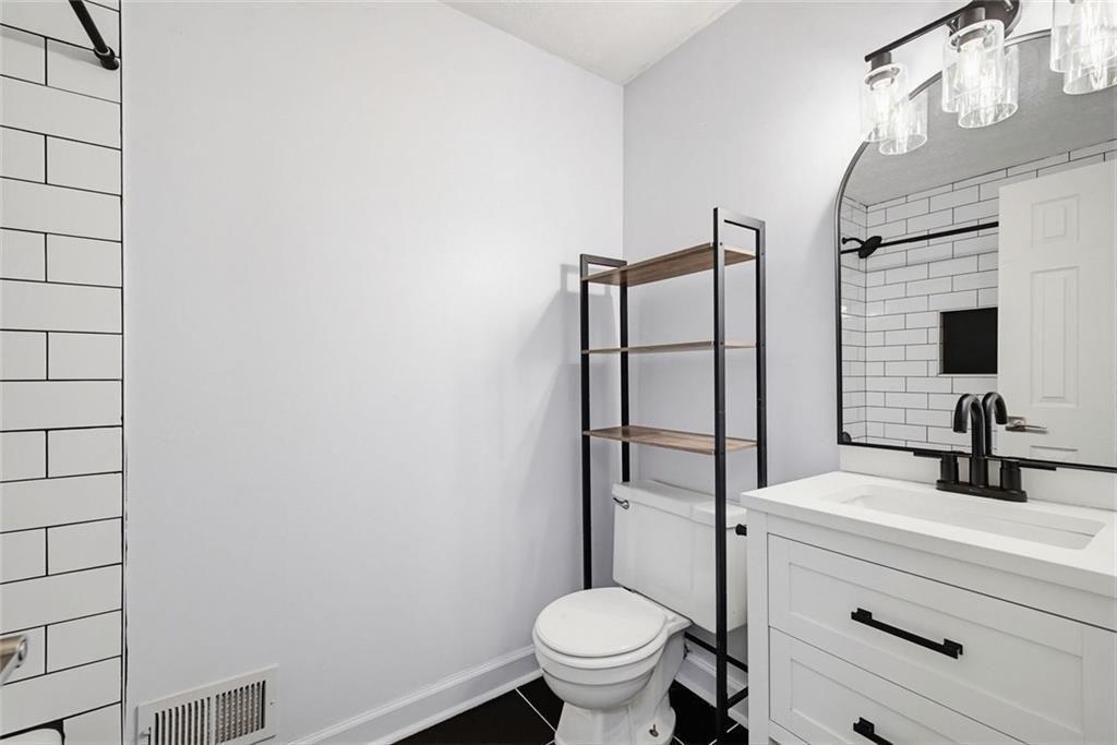 2845 Wood Forest Road Marietta, GA 30066 - Photo 17 of 26 a bathroom with a sink toilet and shower