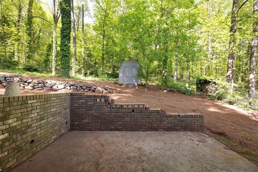 2845 Wood Forest Road Marietta, GA 30066 - Photo 24 of 26 a view of a yard with large tree and wooden fence