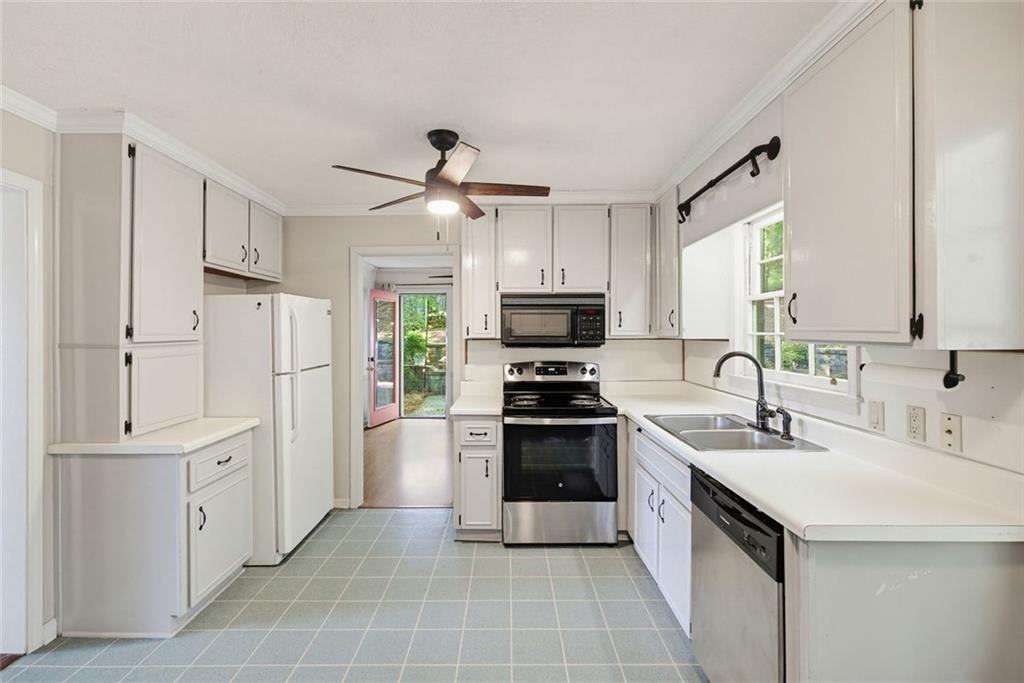 2845 Wood Forest Road Marietta, GA 30066 - Photo 8 of 26 a kitchen with white cabinets and stainless steel appliances