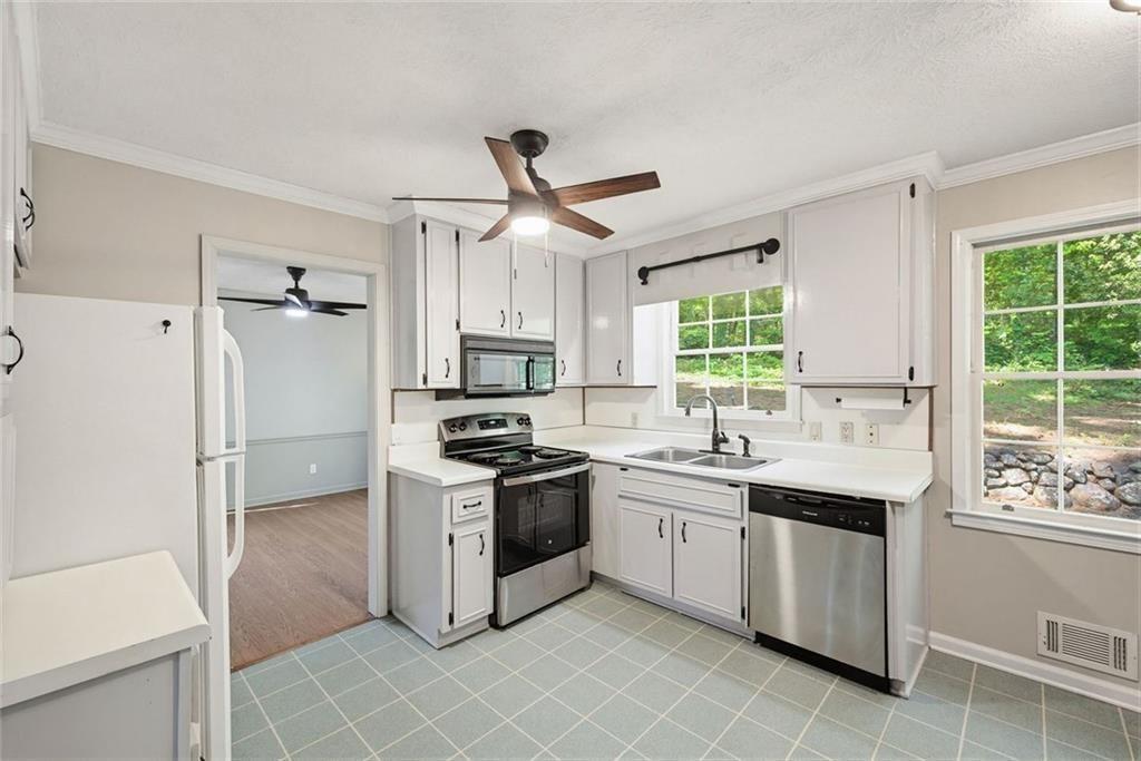 2845 Wood Forest Road Marietta, GA 30066 - Photo 10 of 26 a kitchen with a stove a sink and a refrigerator