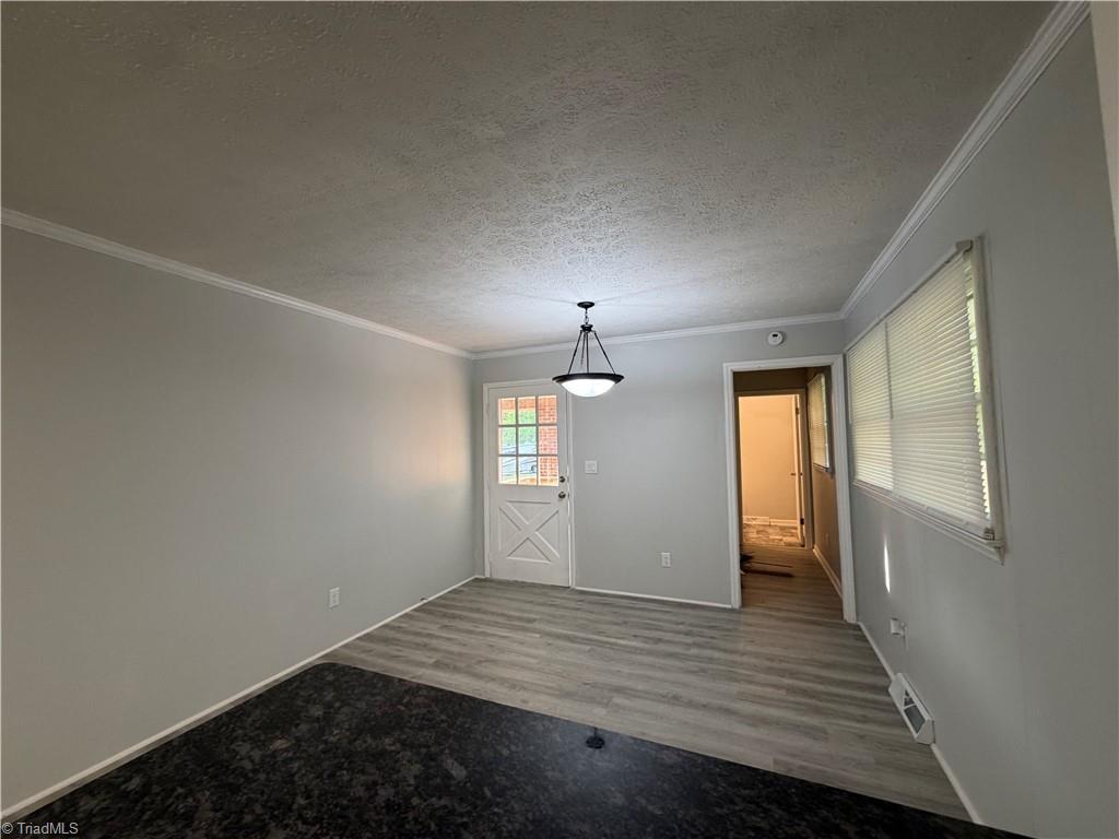 2387 Ashley Loop Reidsville, NC 27320 - Photo 21 of 21 View of dining room from kitchen…this exit is to the carport area on the side of the home and the door on the right is tha laundry room then half bath