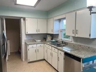 a kitchen with a sink stove and refrigerator