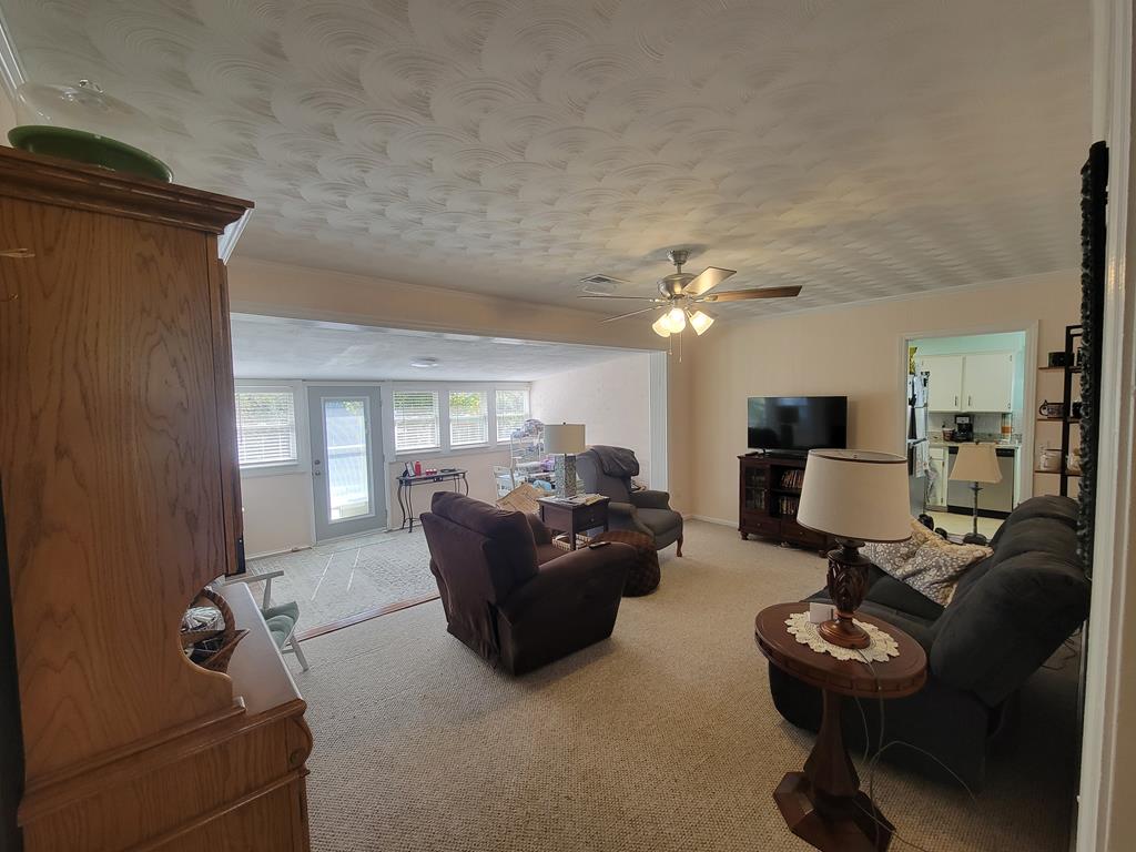 4202 Cheshire Bridge Road Columbus, GA 31909 - Photo 17 of 47 a living room with furniture and a chandelier