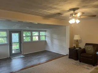 a living room with furniture and a chandelier