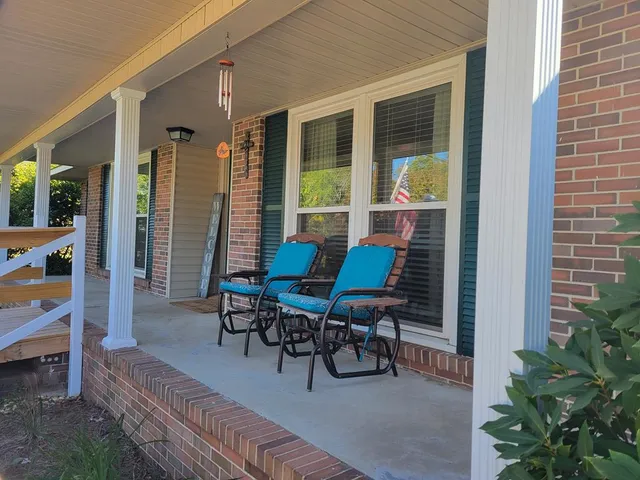 a view of a house with porch and sitting area