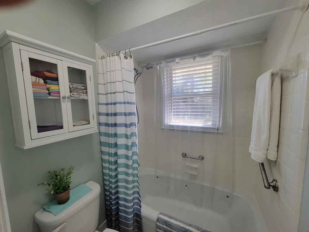 4202 Cheshire Bridge Road Columbus, GA 31909 - Photo 24 of 47 a bathroom with a shower curtain and a window