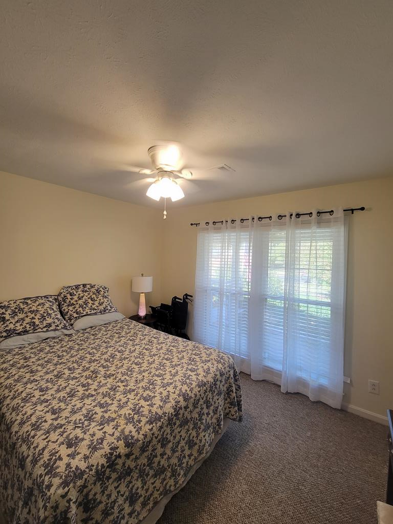 4202 Cheshire Bridge Road Columbus, GA 31909 - Photo 26 of 47 a bedroom with a bed and a chandelier