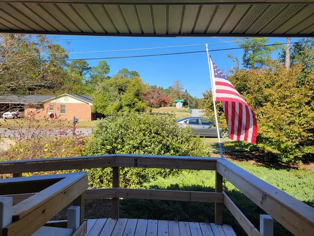 a view of a couple of cars parked on road from a balcony