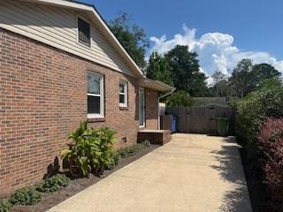 4202 Cheshire Bridge Road Columbus, GA 31909 - Photo 33 of 47 a backyard of a house with plants and tree