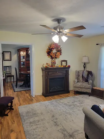 a living room with furniture a dining table and a fireplace