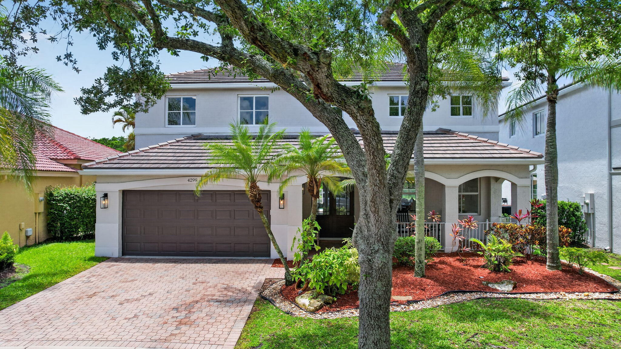 4299 Laurel Ridge Circle Weston, FL 33331 - Photo 102 of 103 a front view of a house with garden