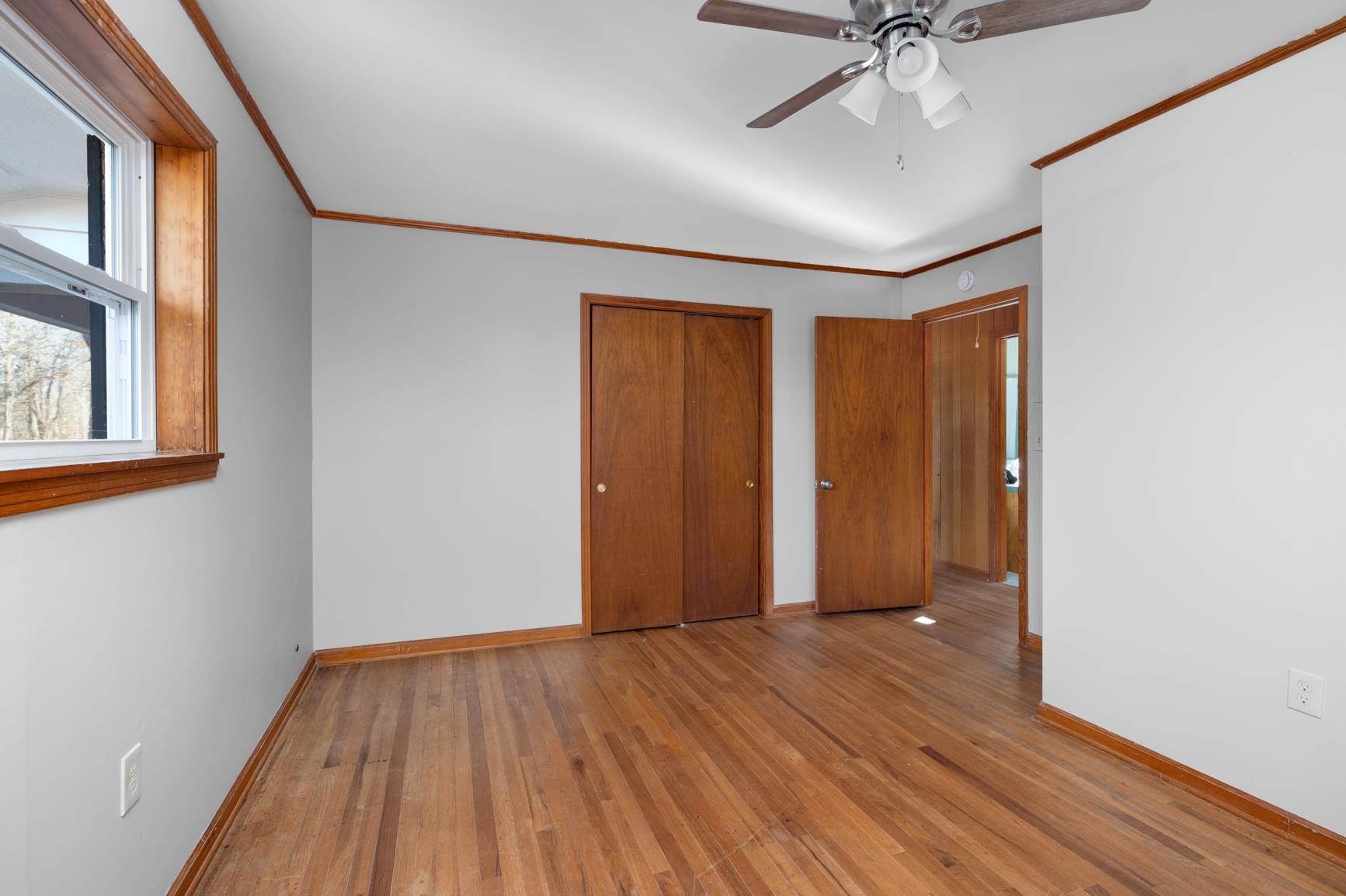 945 Gay Road Burlison, TN 38015 - Photo 1 of 27 a view of an empty room with wooden floor and a window