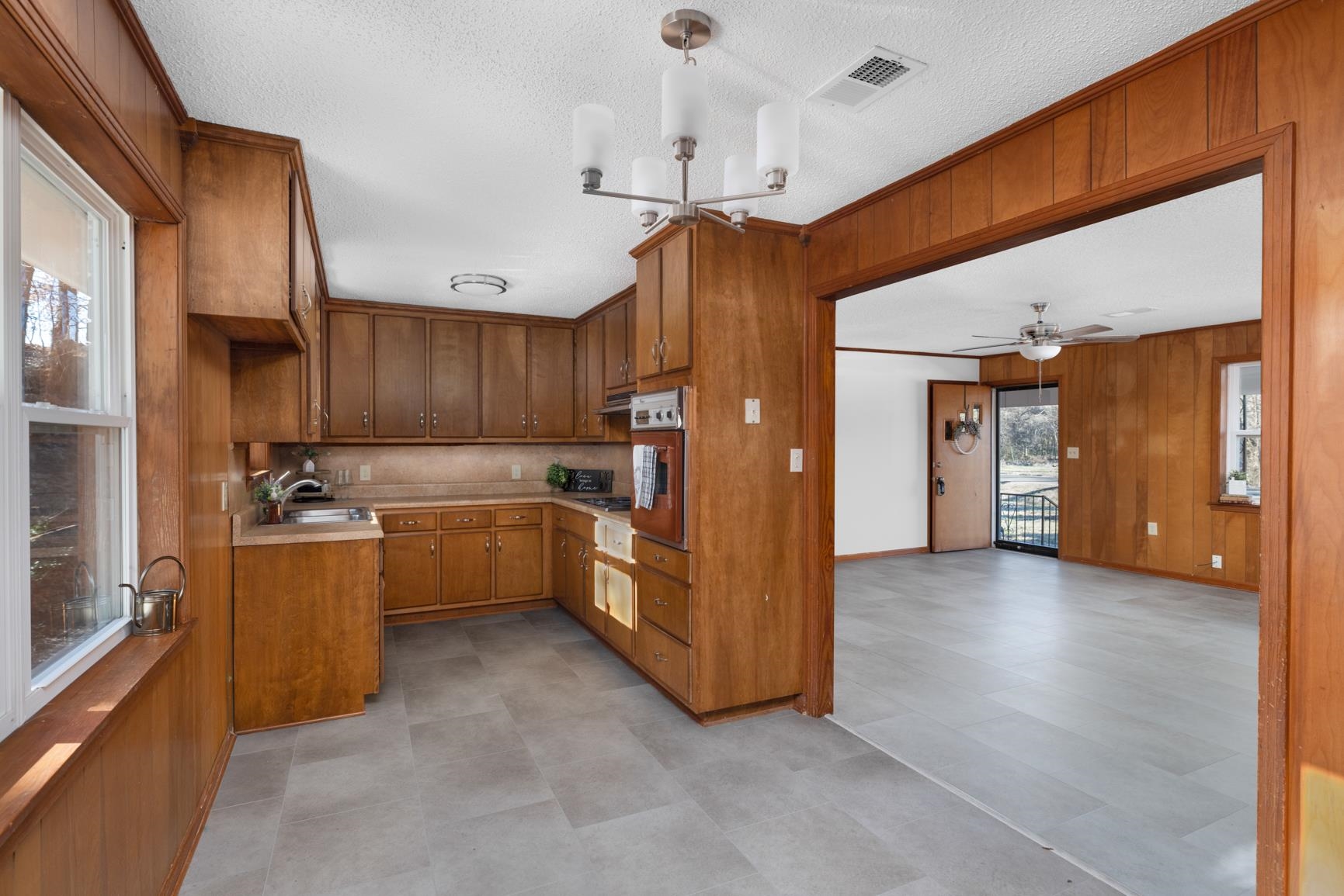 945 Gay Road Burlison, TN 38015 - Photo 14 of 27 a view of a kitchen with a sink and dishwasher a refrigerator with wooden floor