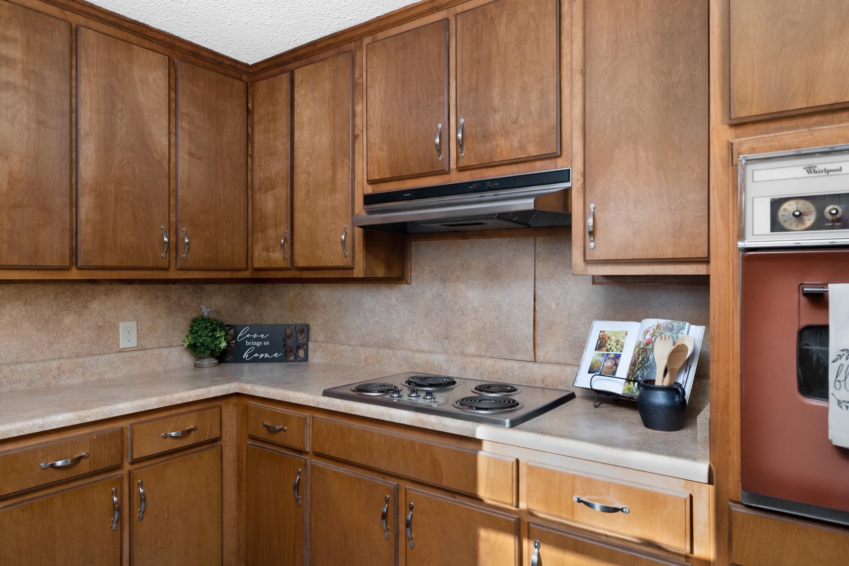 945 Gay Road Burlison, TN 38015 - Photo 18 of 27 a kitchen with wooden cabinets and a stove top oven