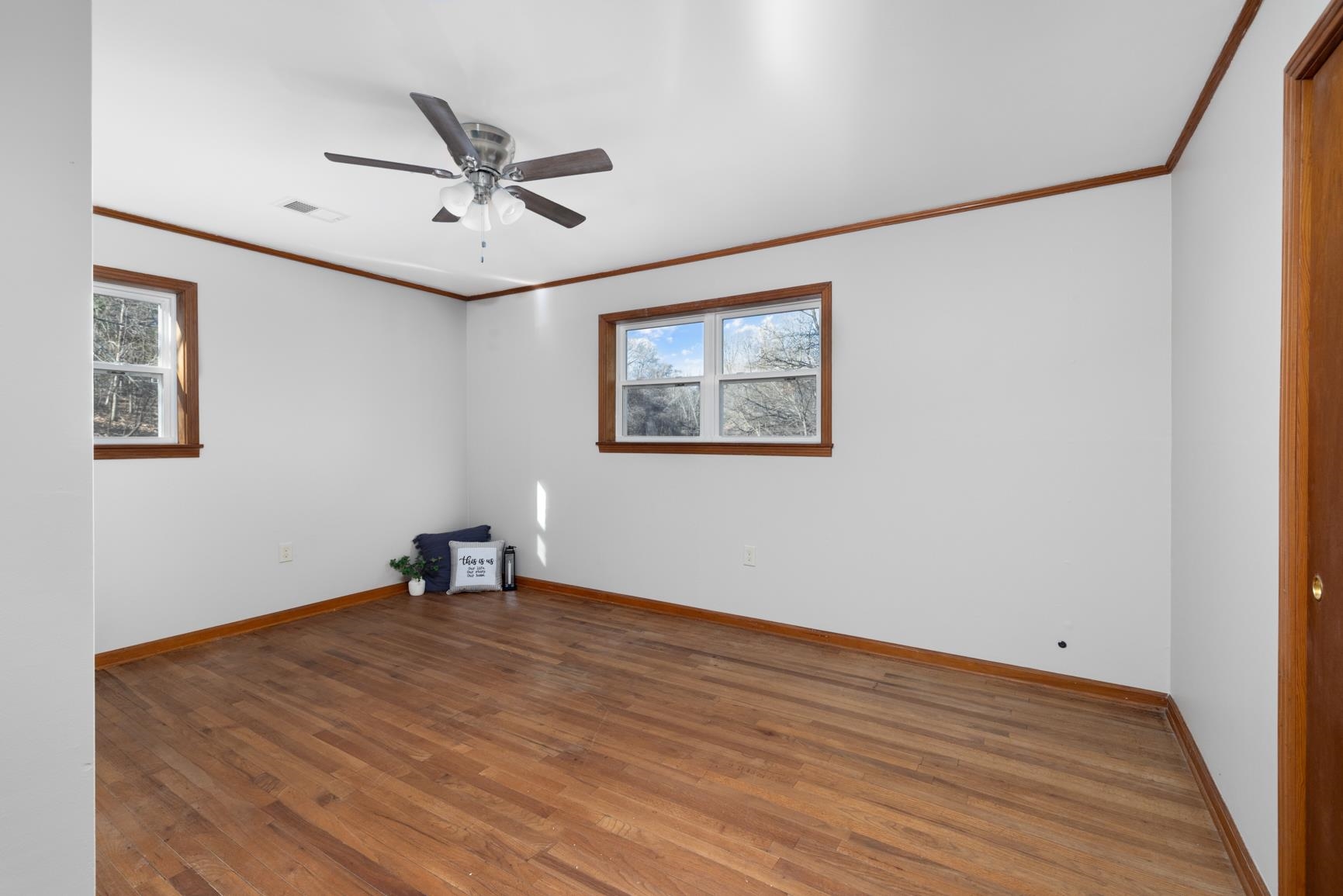 945 Gay Road Burlison, TN 38015 - Photo 20 of 27 a view of a big room with wooden floor and a ceiling fan