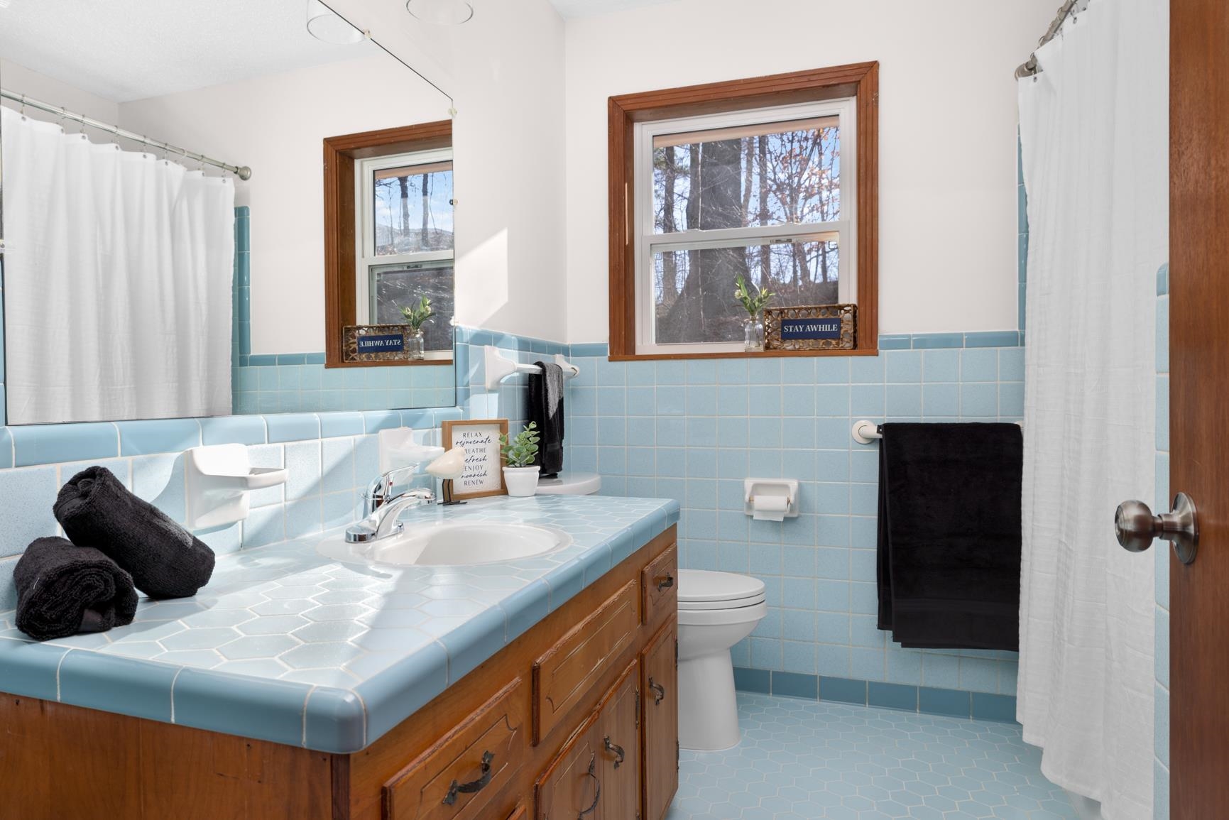 945 Gay Road Burlison, TN 38015 - Photo 2 of 27 Full bathroom featuring a shower with curtain, vanity, wainscoting, tile walls, and light tile patterned floors