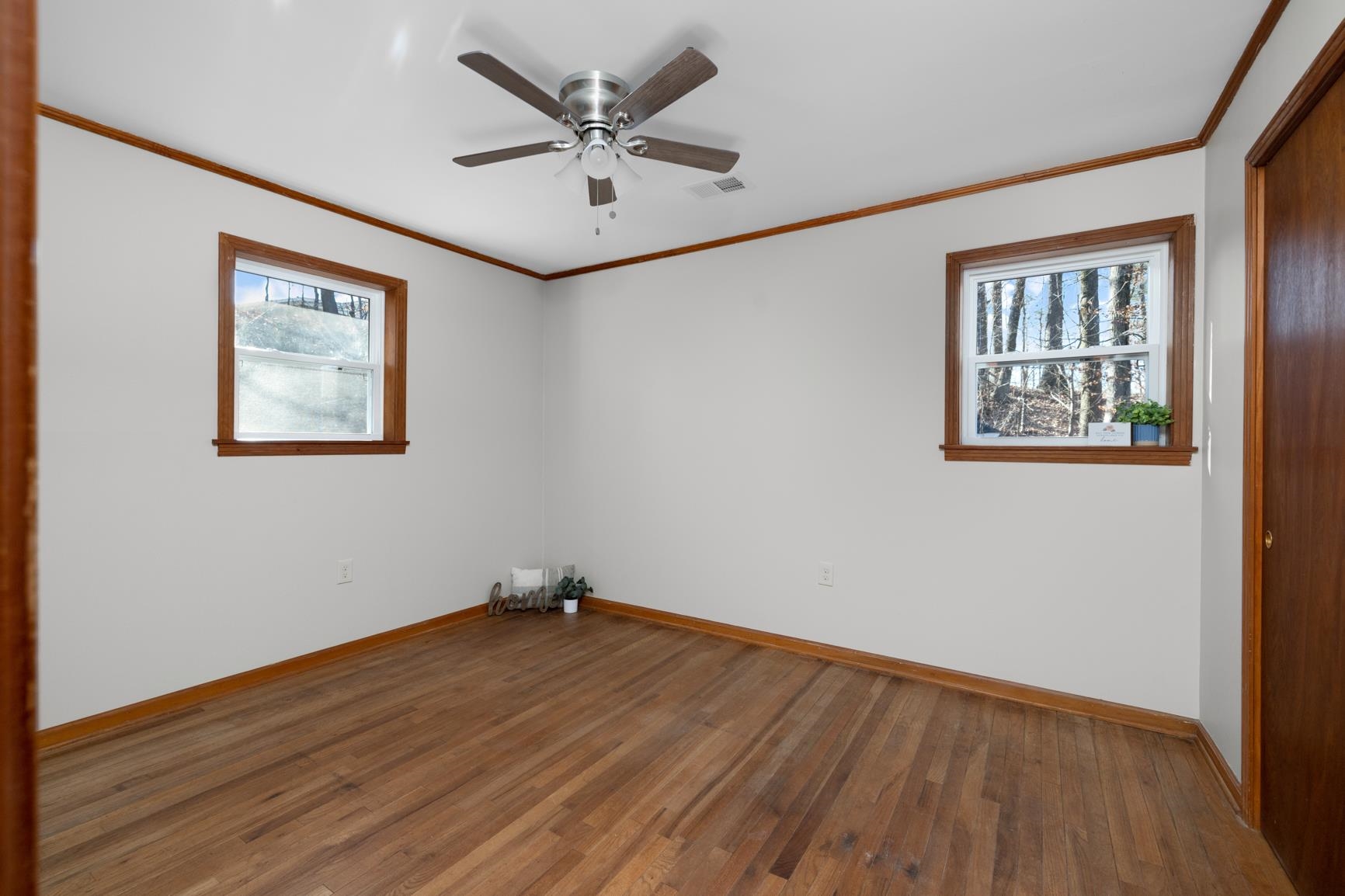 945 Gay Road Burlison, TN 38015 - Photo 3 of 27 an empty room with wooden floor and windows