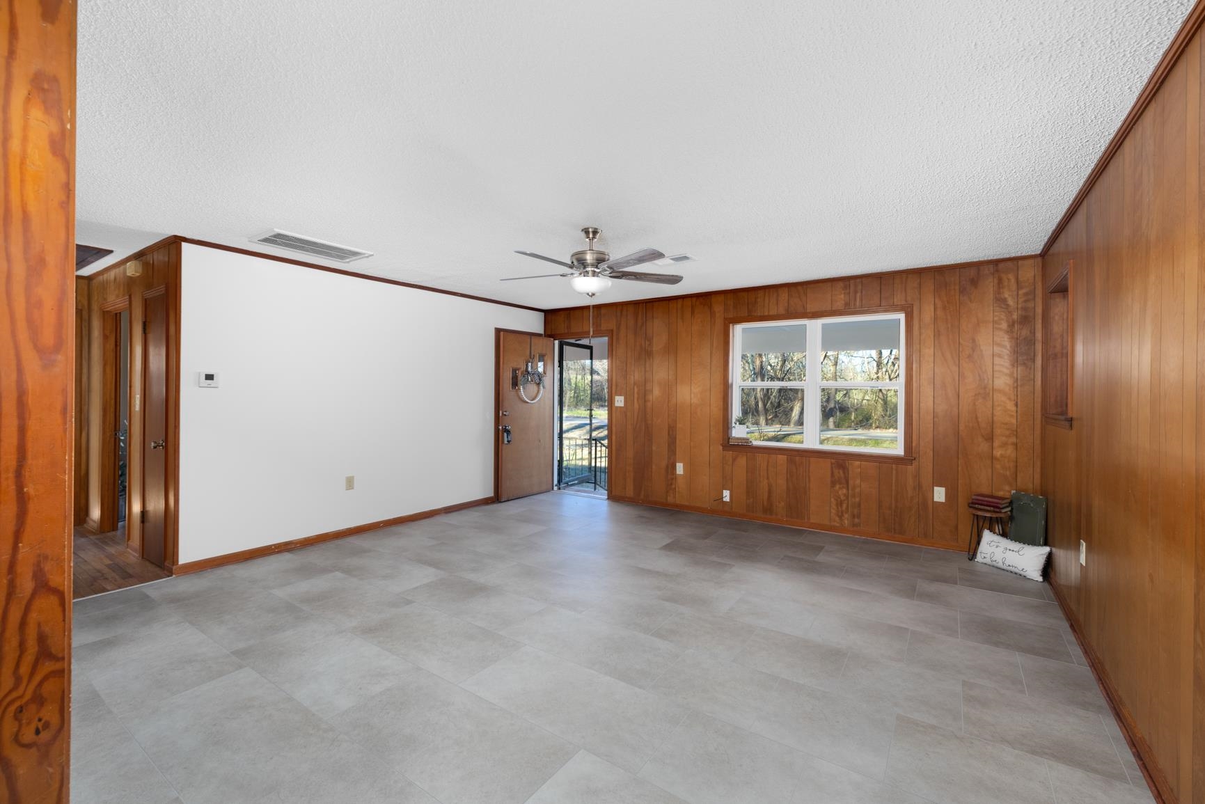 945 Gay Road Burlison, TN 38015 - Photo 10 of 27 an empty room with windows and chandelier fan