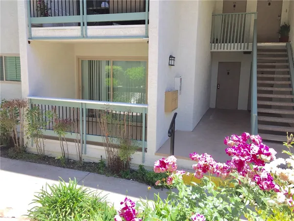 a view of a porch with a flower garden