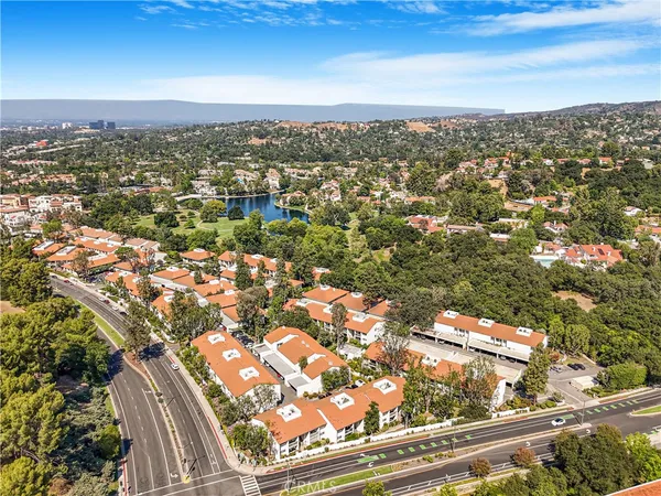 an aerial view of residential building with trees