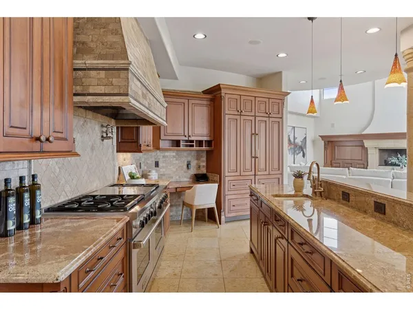 a kitchen with stainless steel appliances granite countertop a stove a sink dishwasher and cabinets with wooden floor