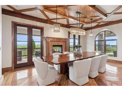 a view of a dining room with furniture wooden floor and a chandelier