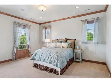 a spacious bedroom with a bed and a window