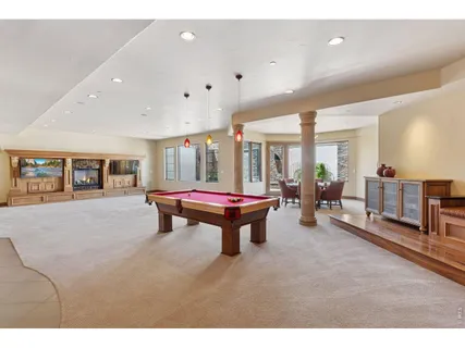 a room with furniture and pool table