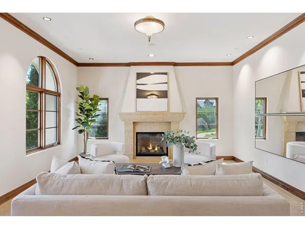 a living room with furniture fireplace and window