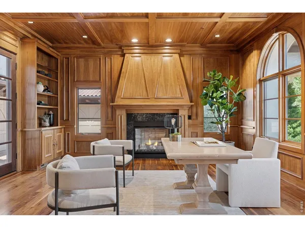 a living room with furniture a fireplace and a table