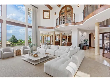 a living room with furniture and a floor to ceiling window