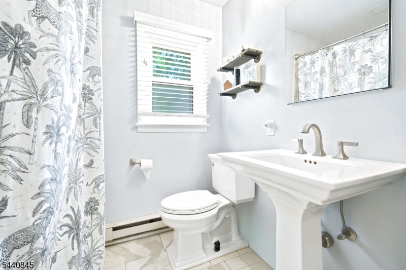 36 Forest Road Andover, NJ 07821 - Photo 40 of 50 a bathroom with a toilet sink and mirror