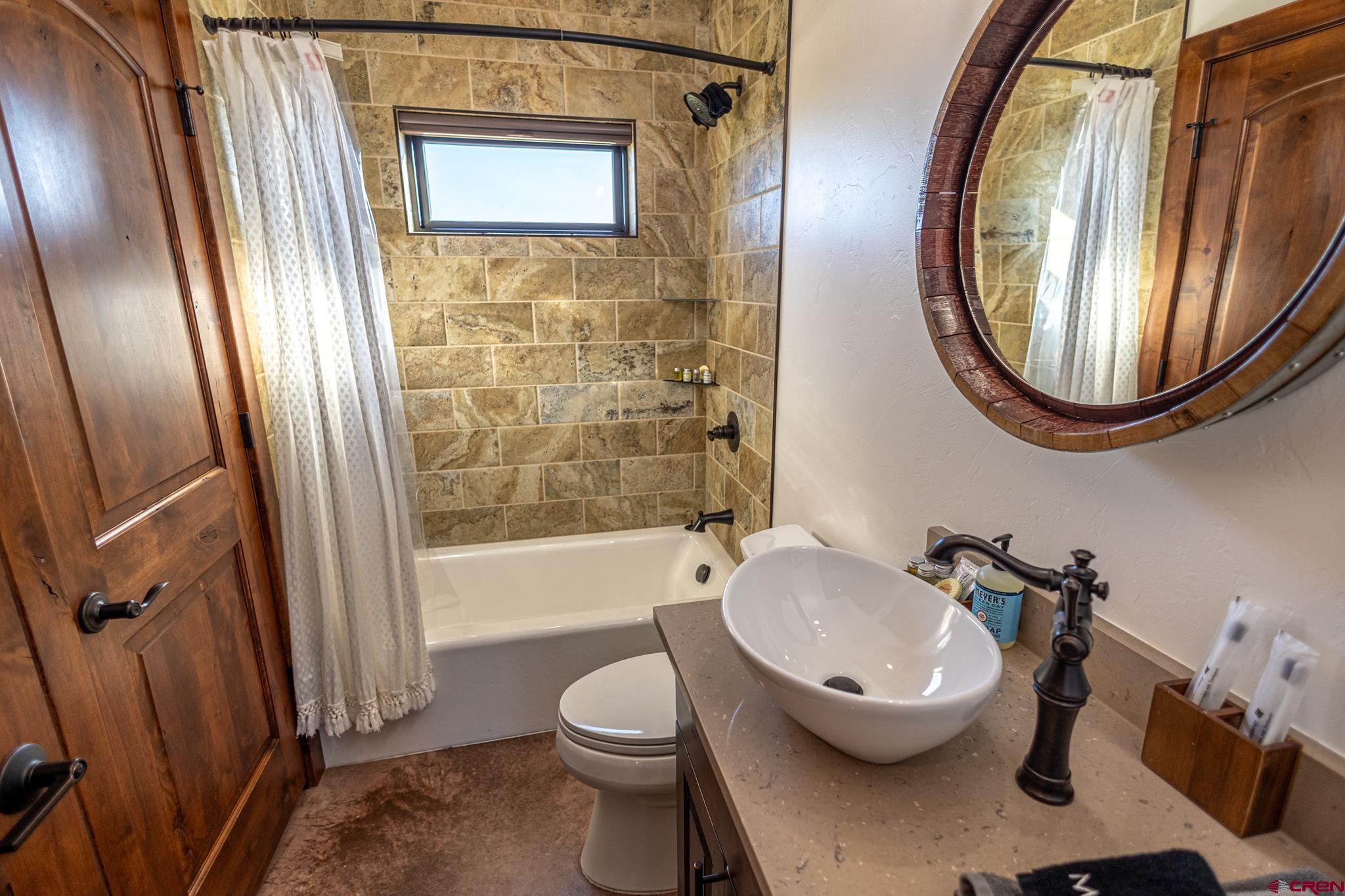a bathroom with a sink a toilet and bathtub